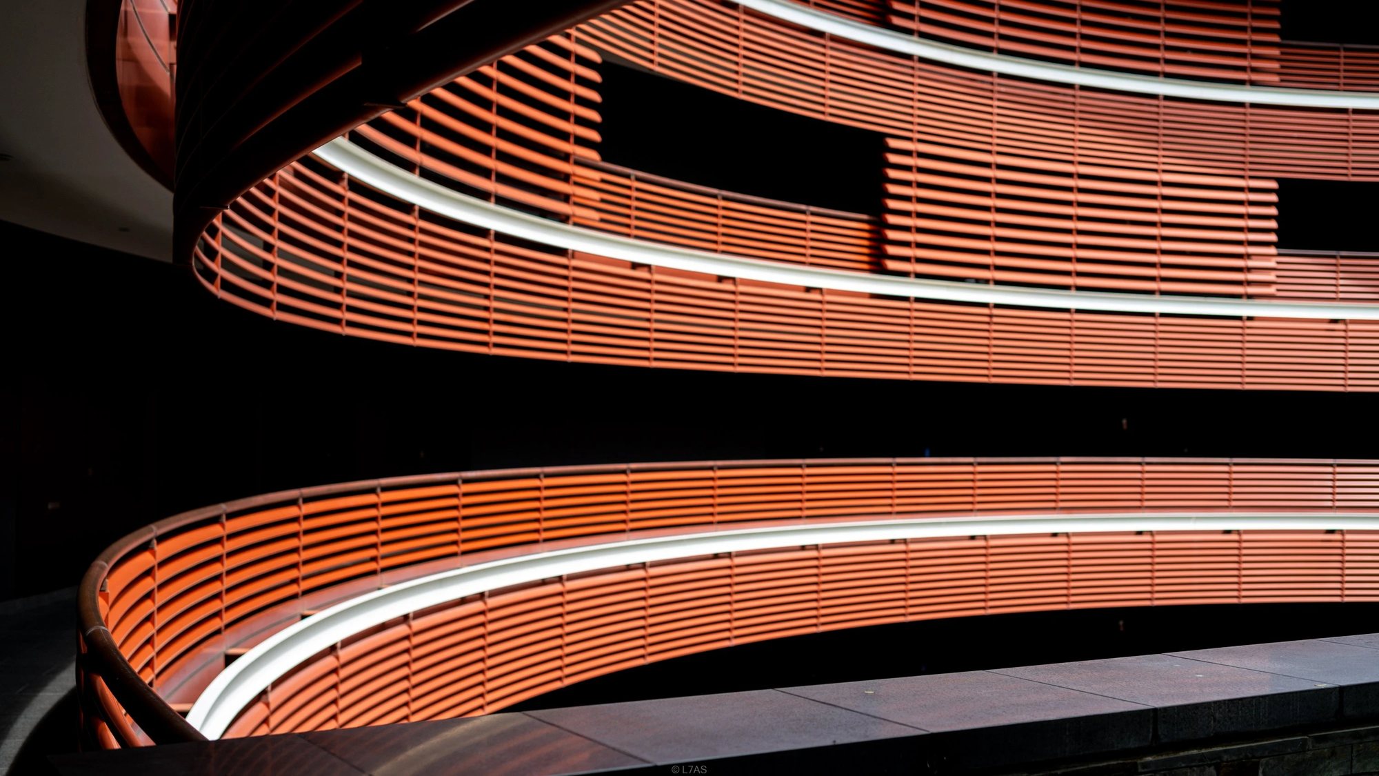 The curving timber-slatted balconies of the Foster wing