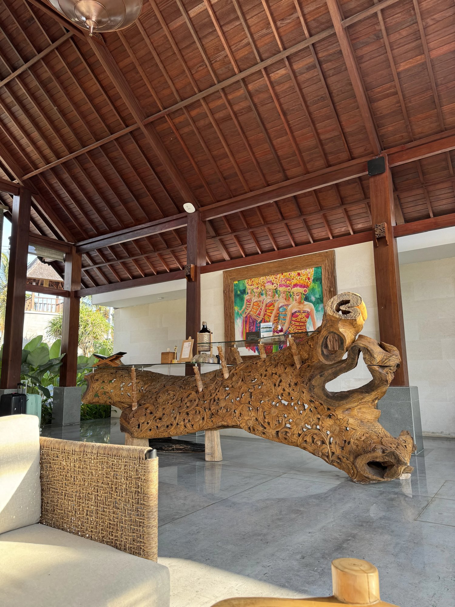 The reception desk, carved from a single tree root, in an open pavilion