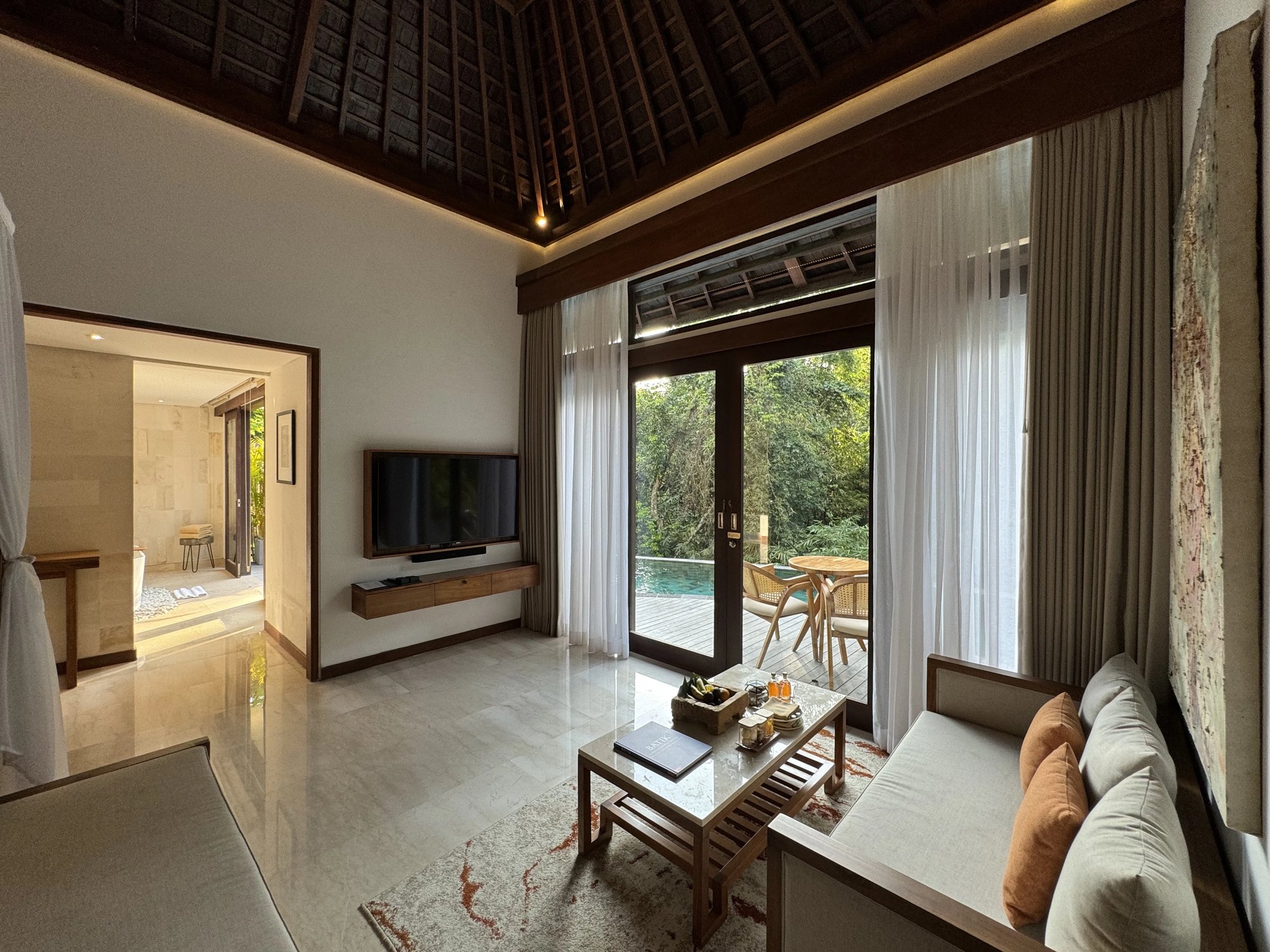 A villa living room, with glass doors to the pool deck