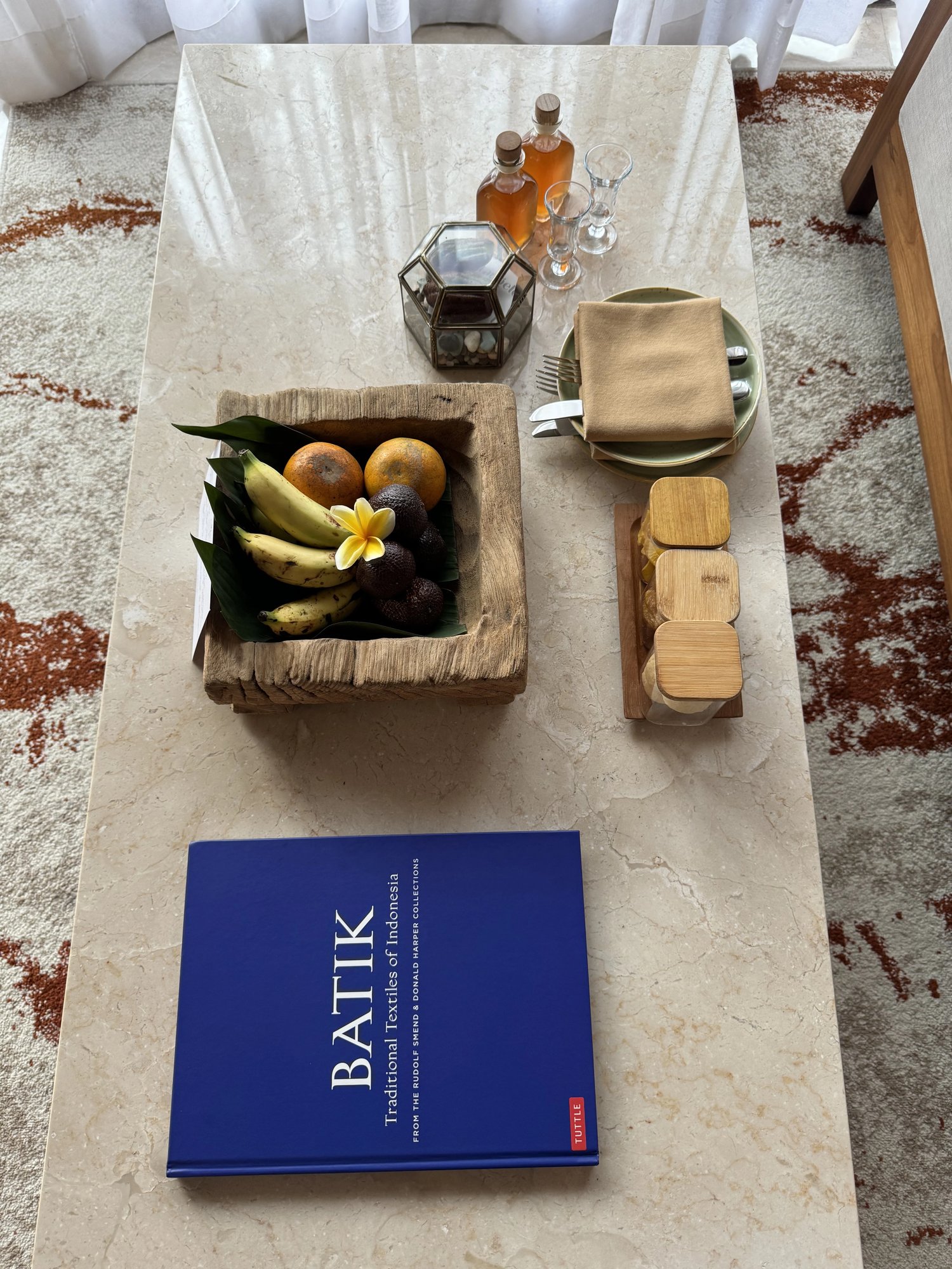A welcome tray of fruit in a carved wooden bowl