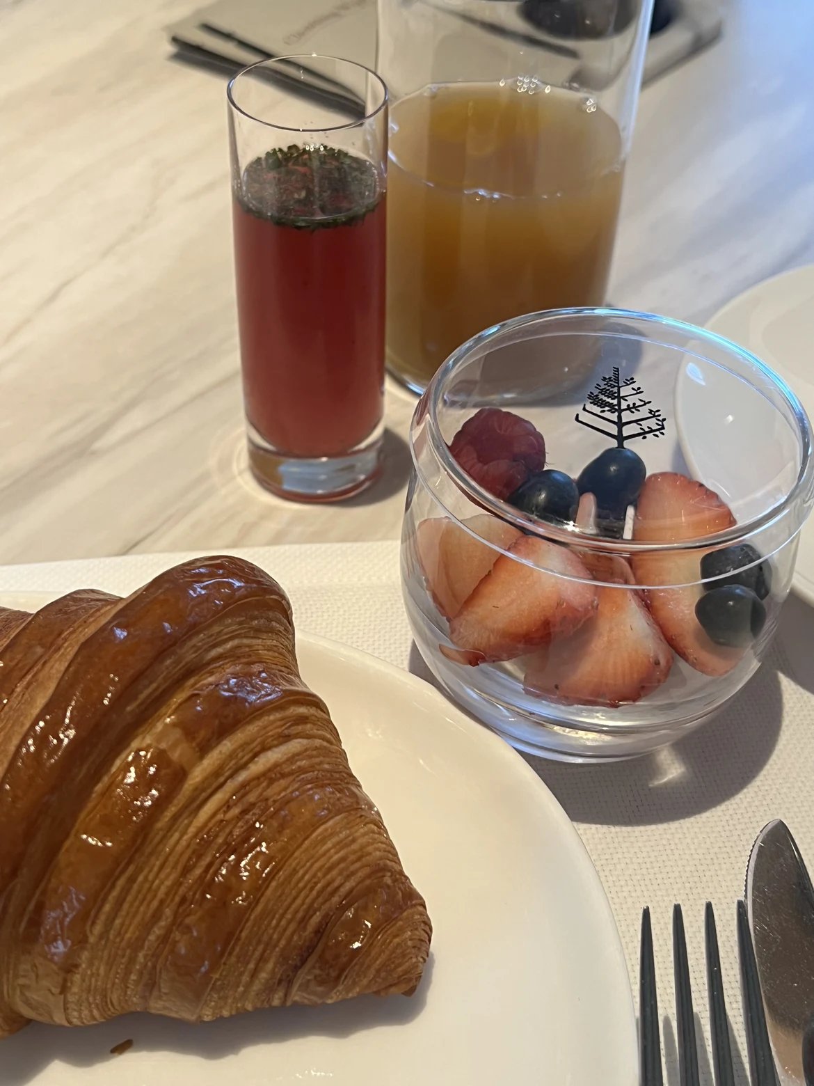 Breakfast croissant, strawberries and juices