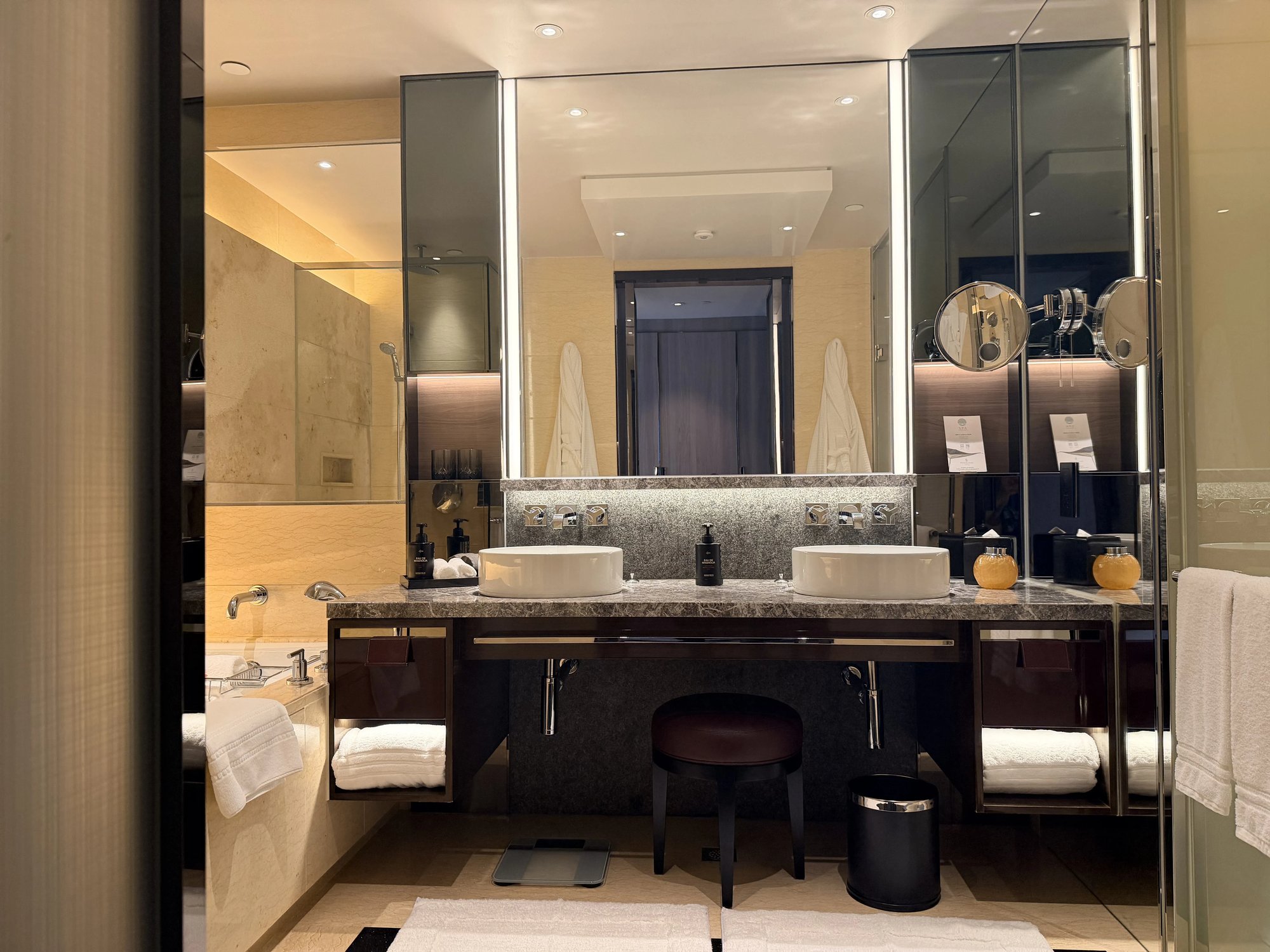 The bathroom with a double vessel vanity and mirrors