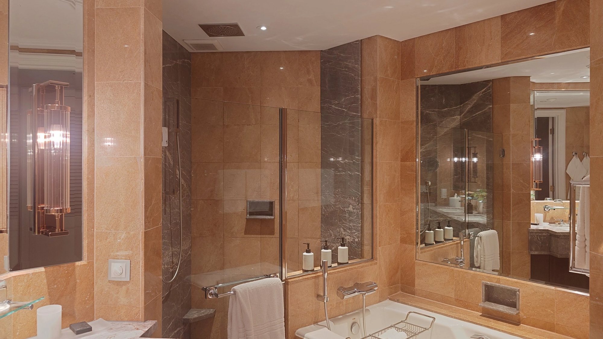 The marble bathroom with tub and walk-in shower