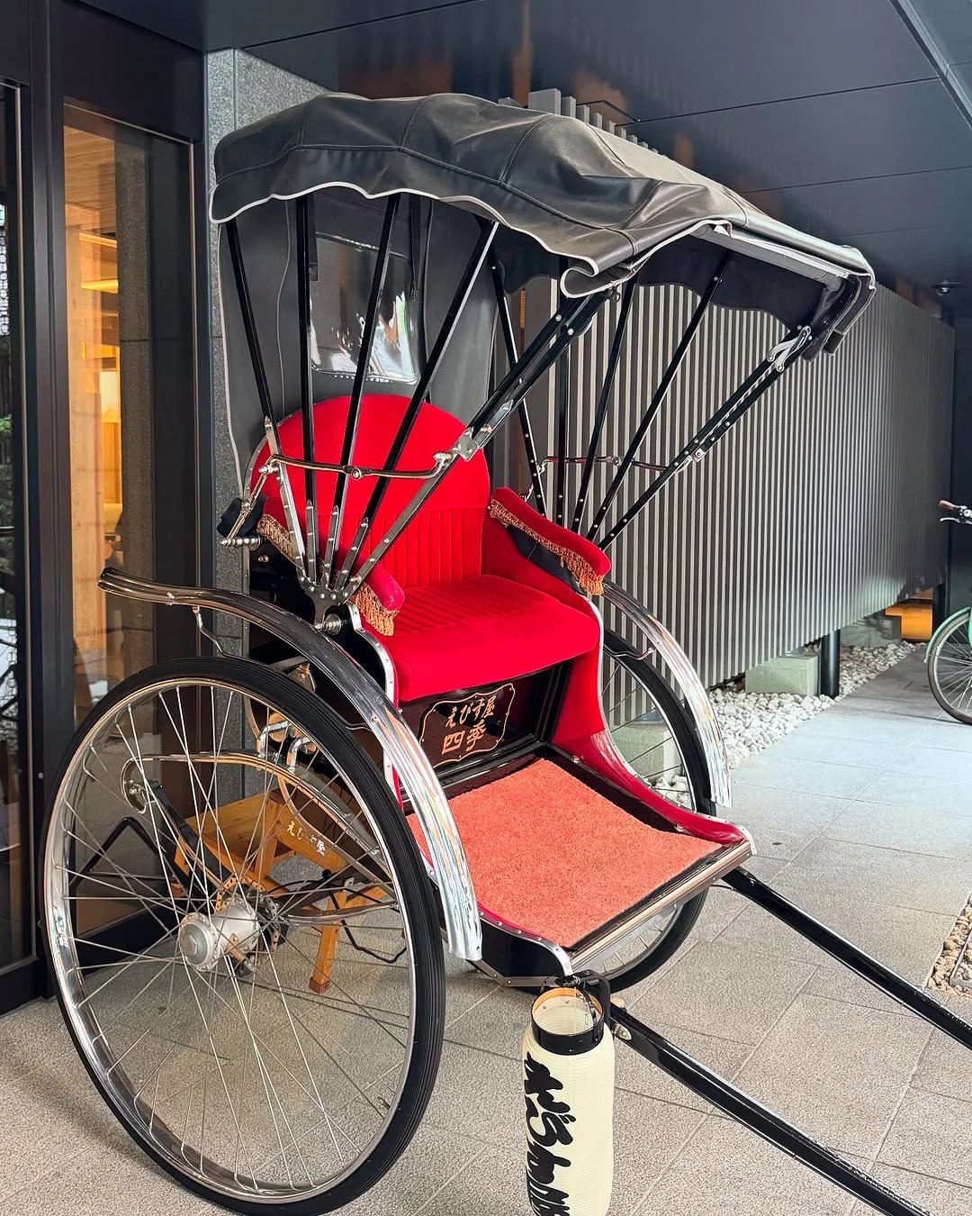 A red rickshaw displayed by the entrance