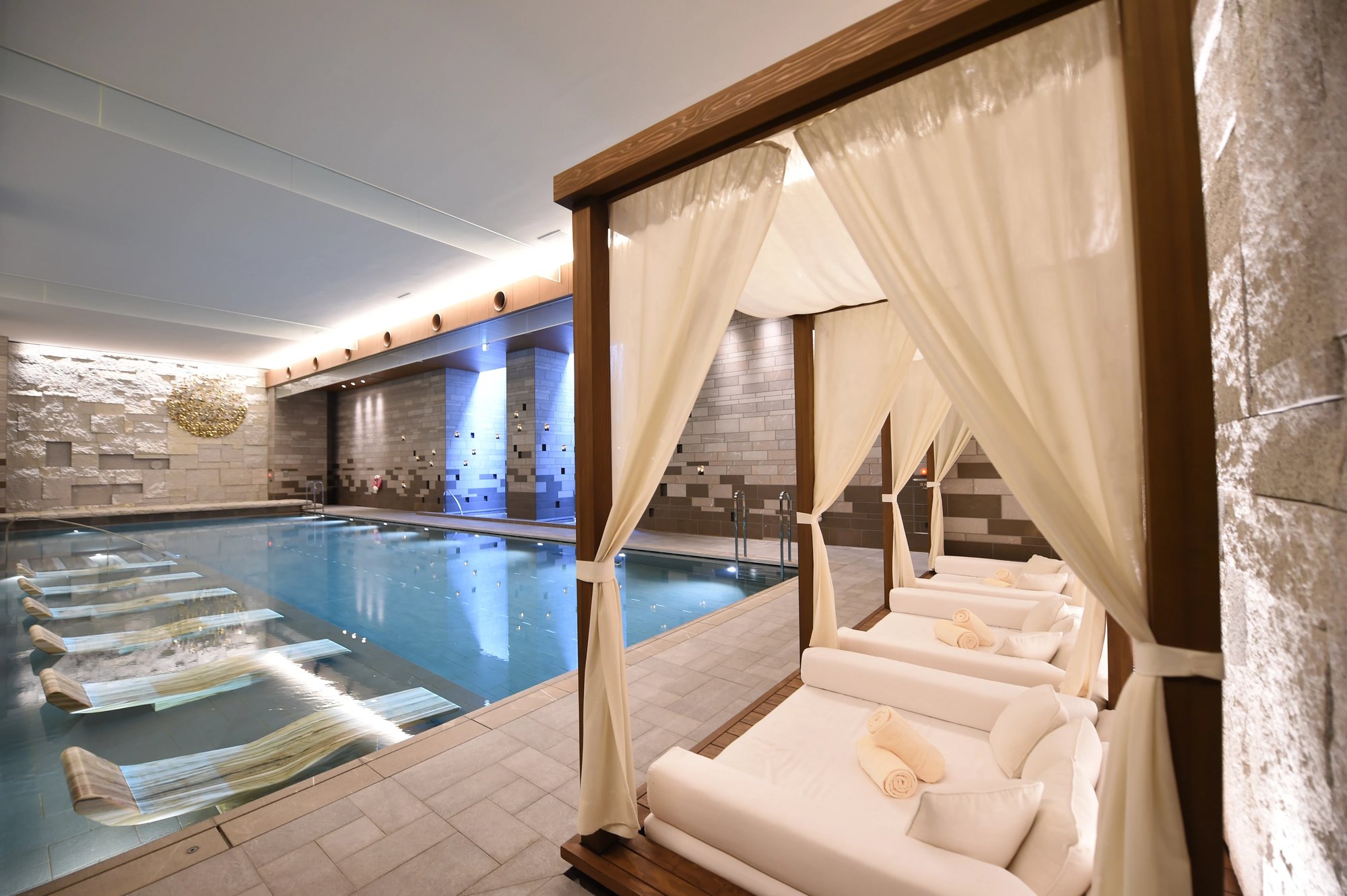The indoor pool with a draped cabana