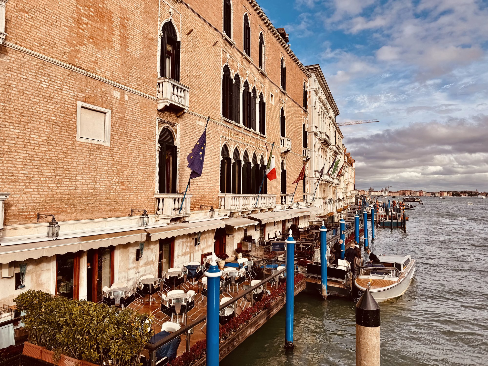 The Gritti Palace facade on the Grand Canal with its terrace and mooring poles