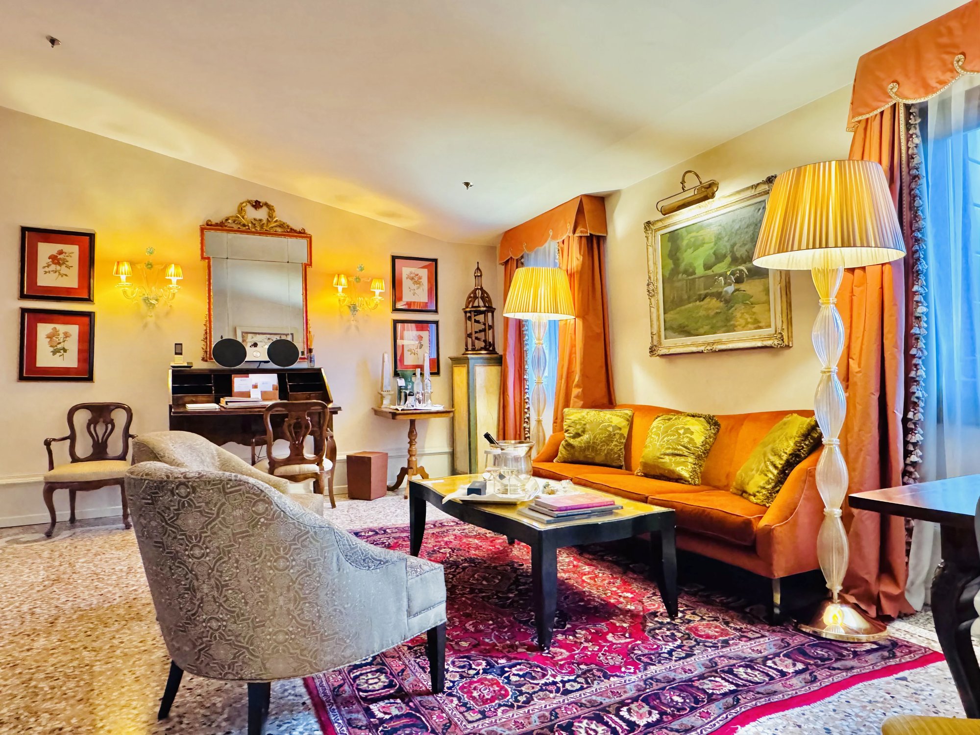 The Serenissima Suite living room with a wide rug and B&O speaker