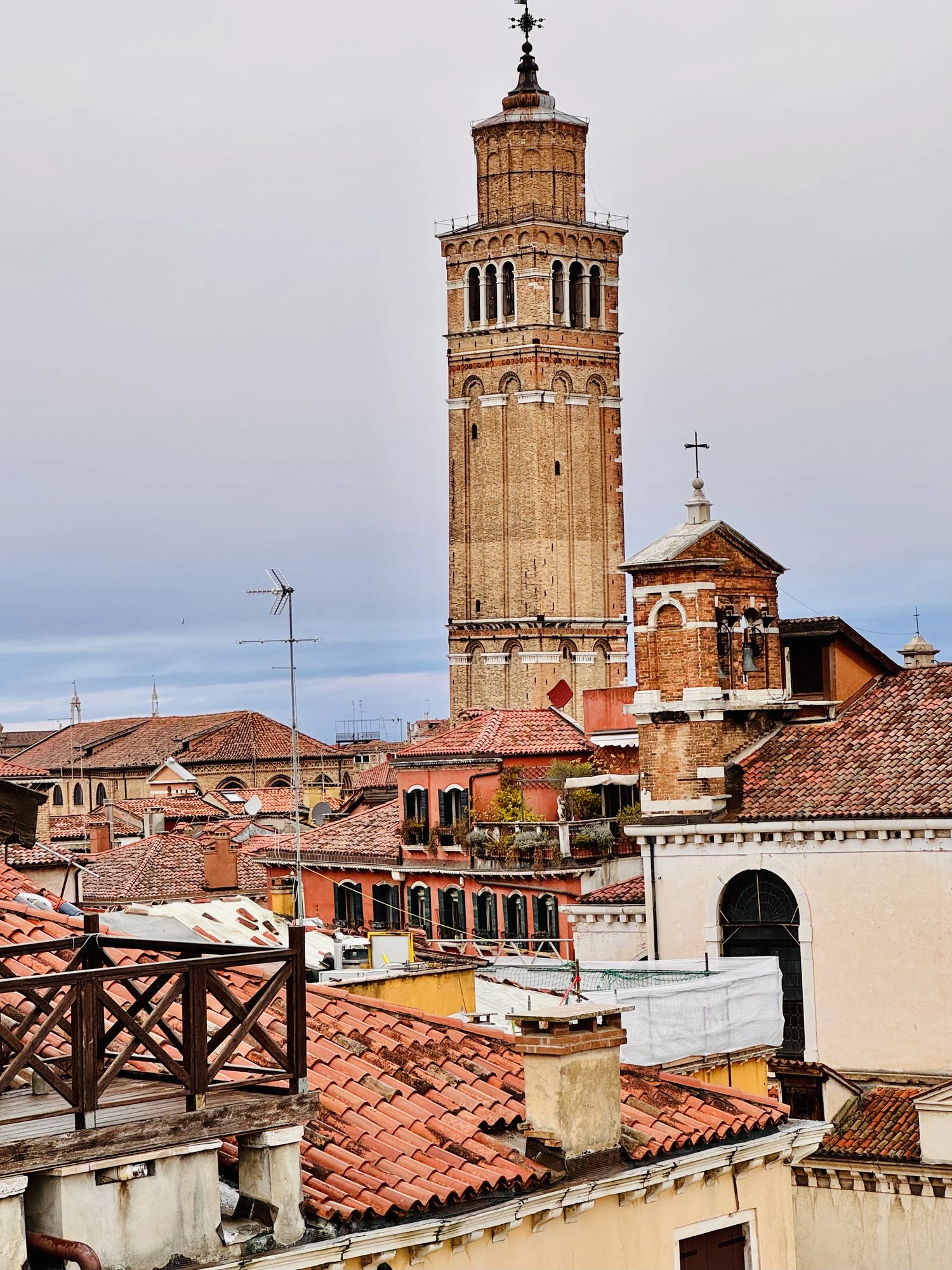 The window view over Venice rooftops to a campanile