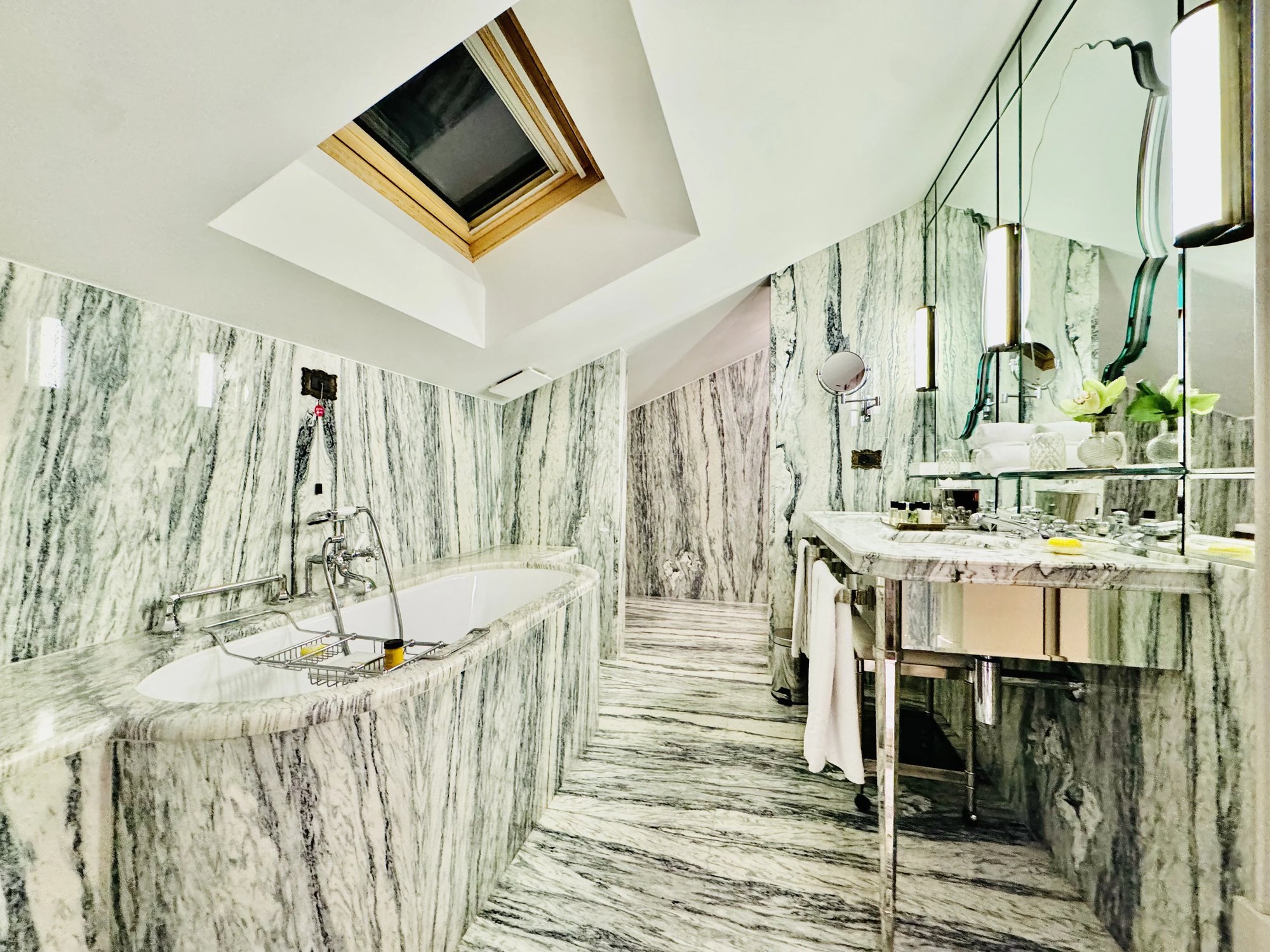 The marble bathroom with skylight, tub and double vanity