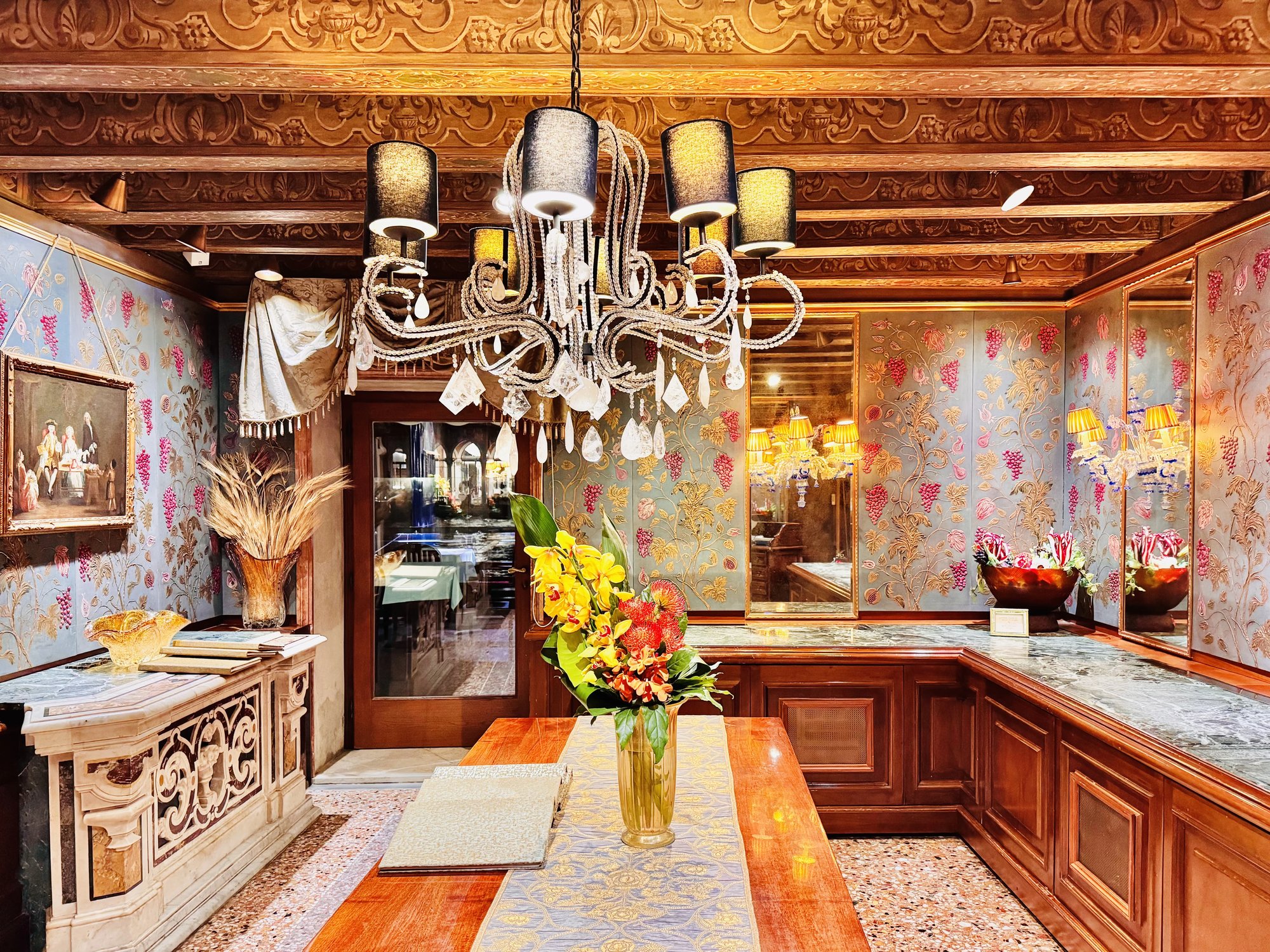 The Club del Doge dining room with chandelier and beamed ceiling