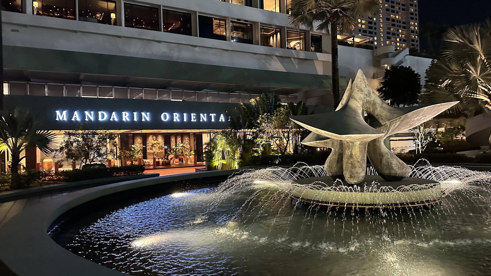 The entrance fountain sculpture lit at night