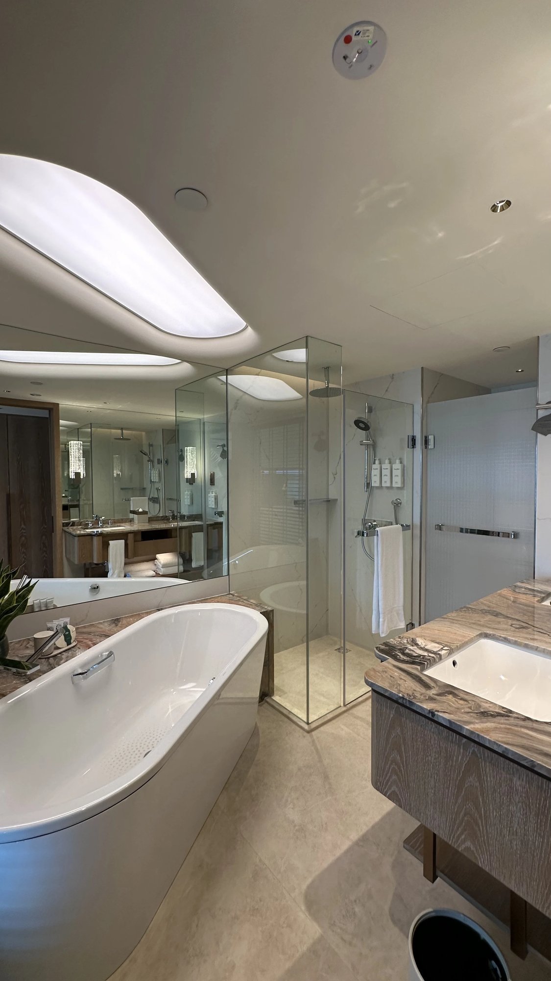 The bathroom with a freestanding tub and a glass shower