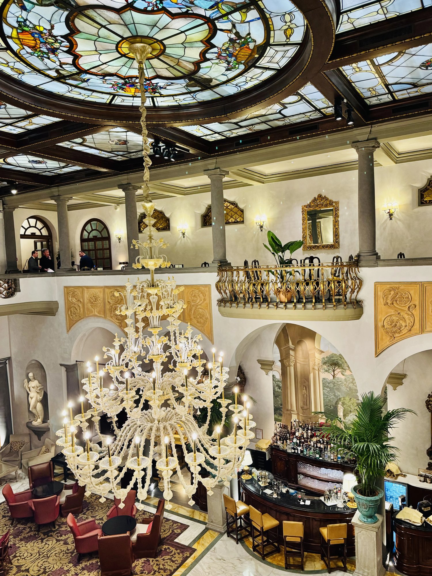 The stained-glass ceiling above the atrium chandelier