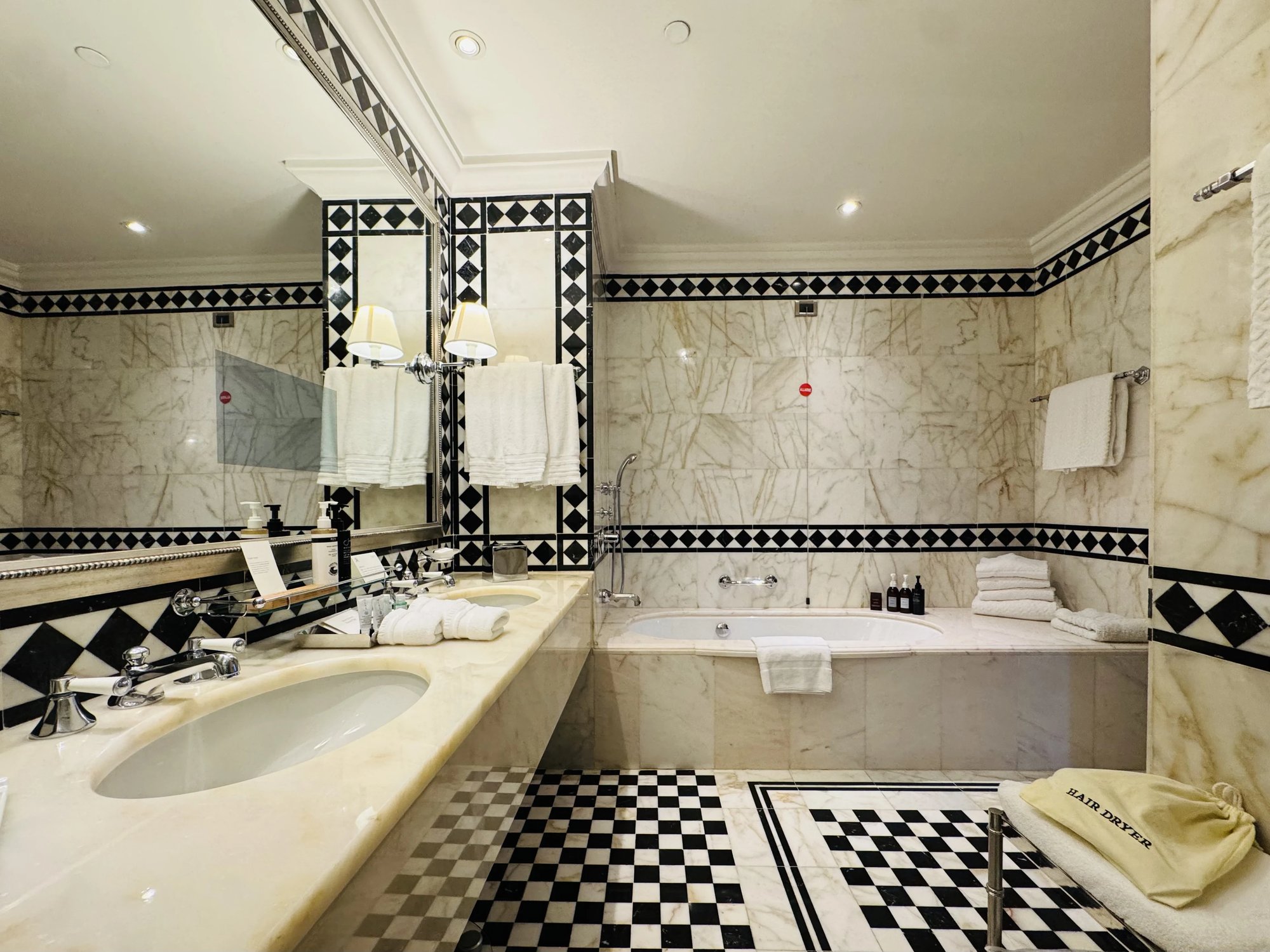 The marble bathroom with tub and chequerboard floor