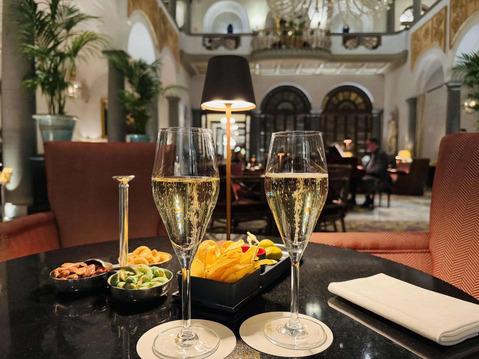 Two glasses of sparkling wine with snacks in the atrium