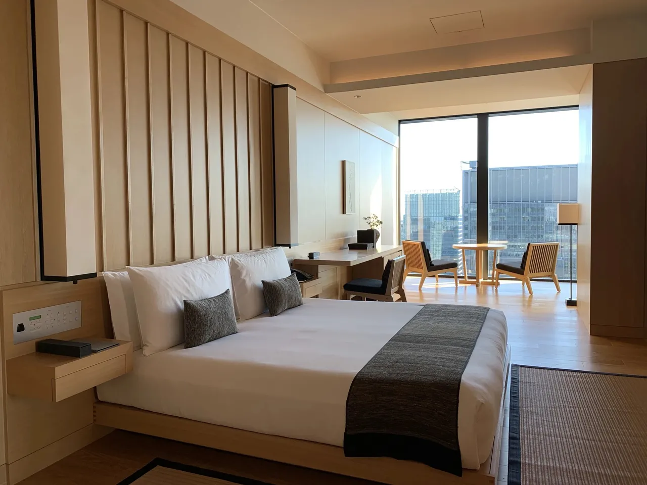 Aman Tokyo: a suite in pale wood and washi screens, with the city through the window