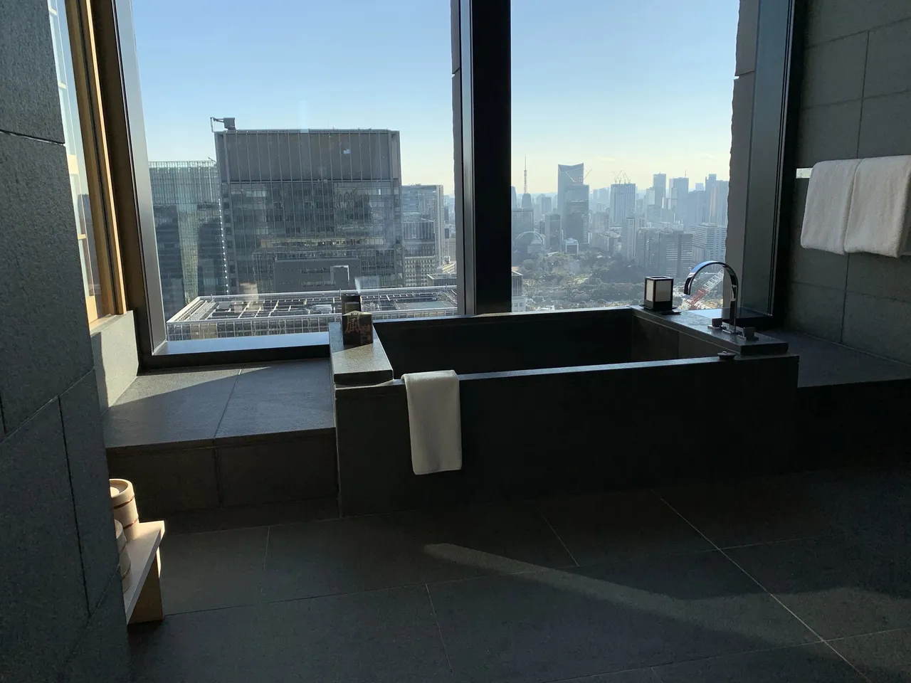 Aman Tokyo: the deep stone furo set against the window