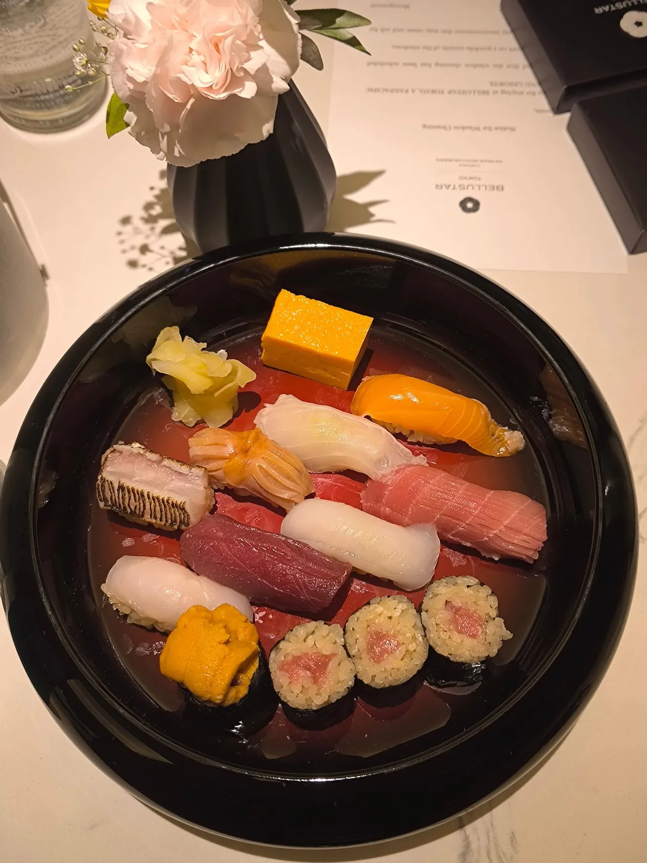 A lacquer bowl of assorted sushi from Jinshin
