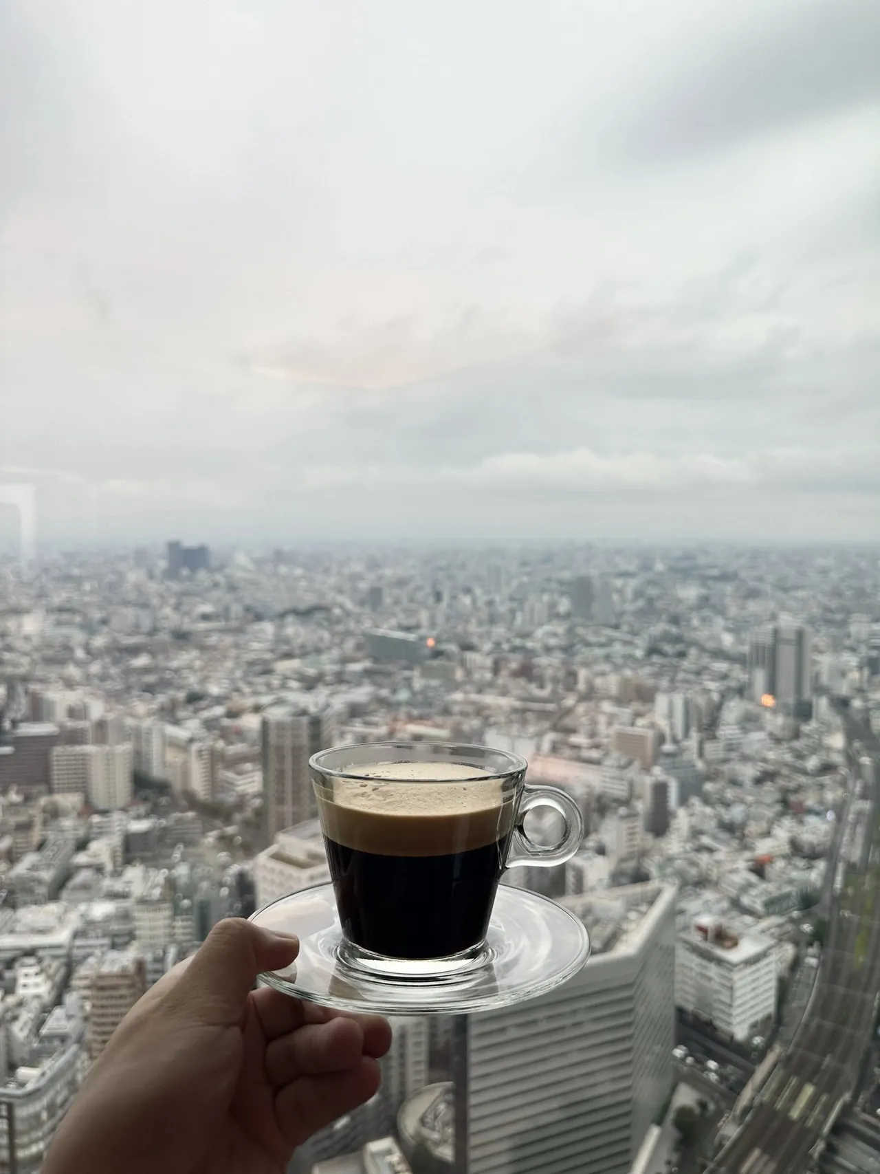 An espresso held up against the skyline