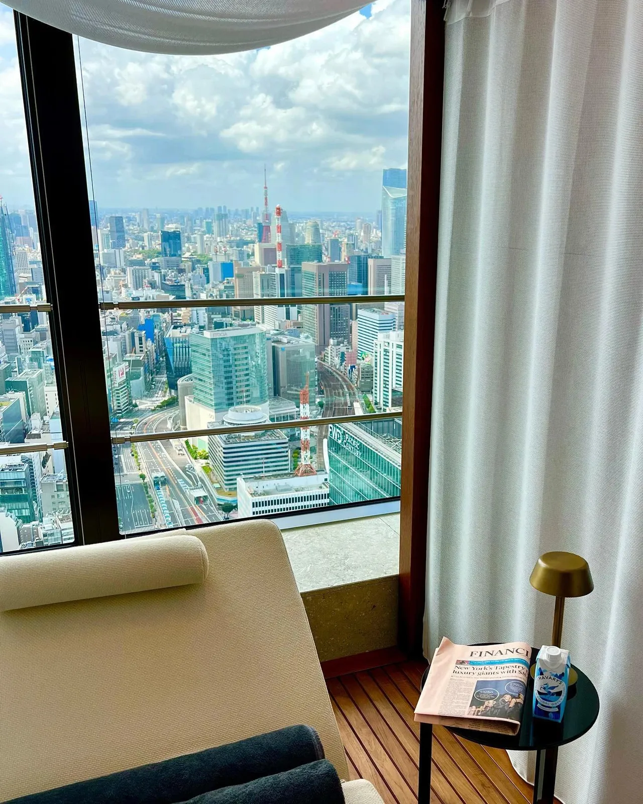 A relaxation chair at a floor-to-ceiling window over the Tokyo skyline