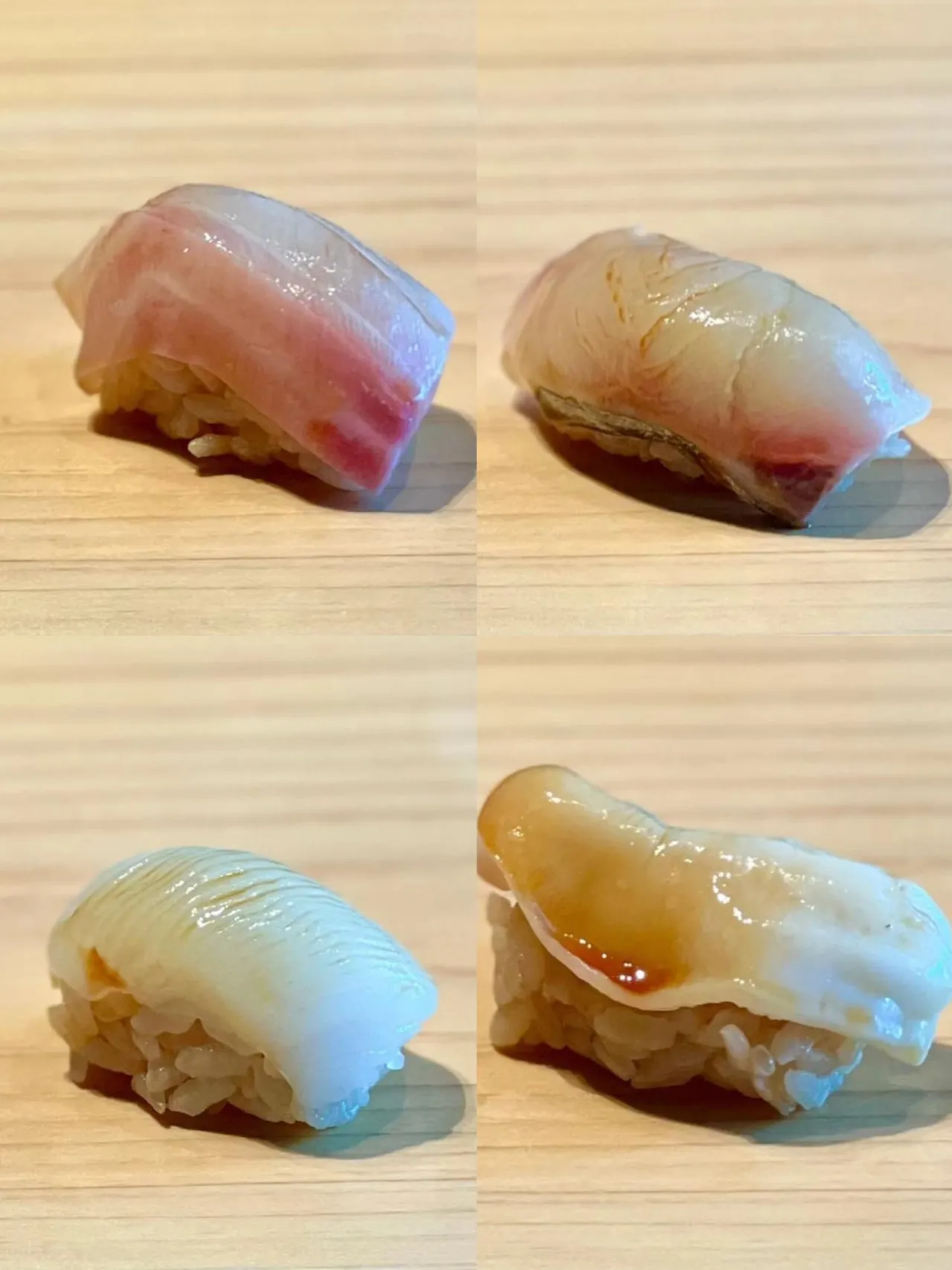 Four pieces of nigiri on a wooden board