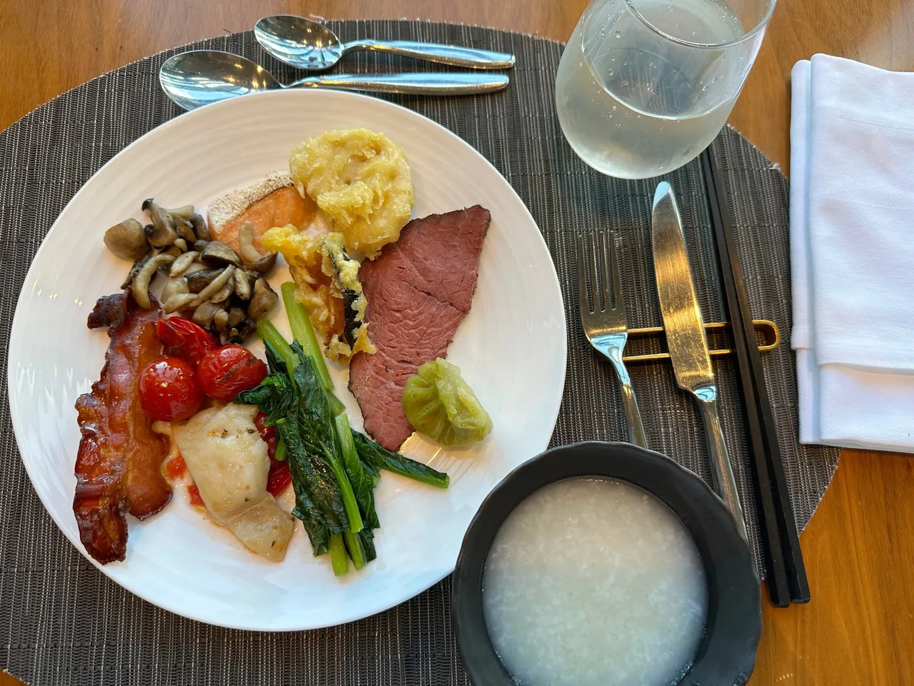 A breakfast plate of roast beef, mushrooms, asparagus and congee