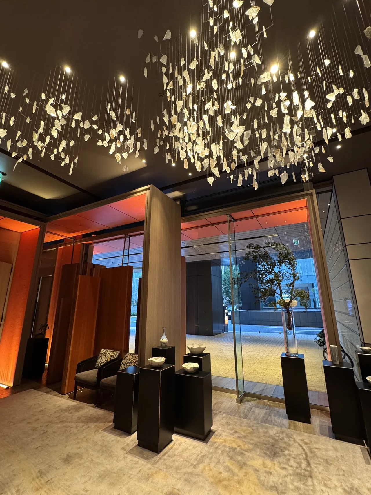 A cloud of silver leaf chandelier above the entrance lobby