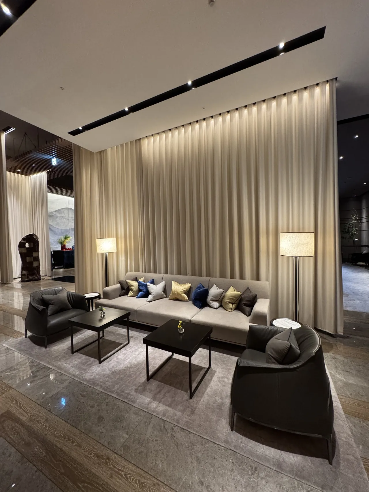 Lobby sofas behind a long curtain wall