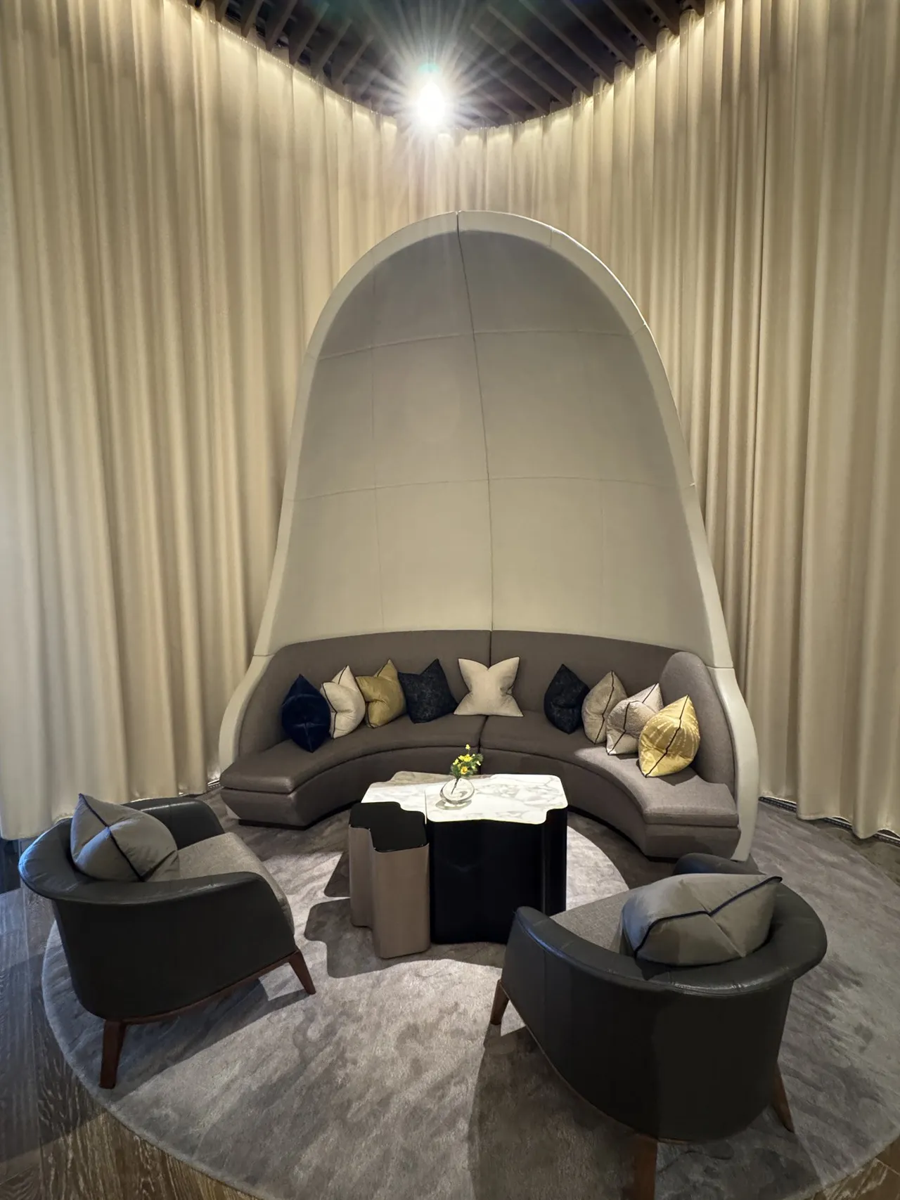 A curved lobby alcove with round seating