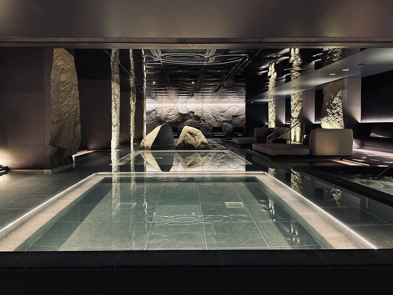 The thermal spring pool hall with a long still pool between stone columns