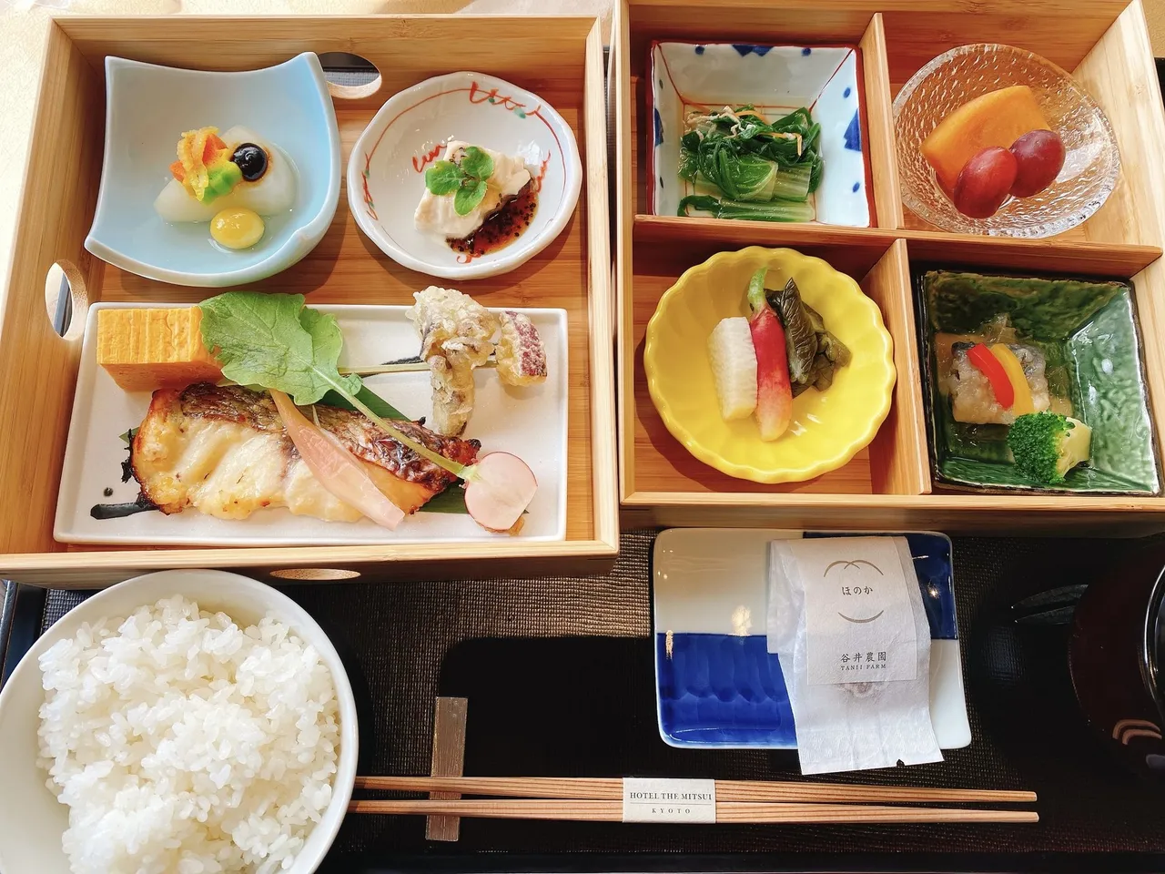 A Japanese breakfast box with grilled fish and small dishes