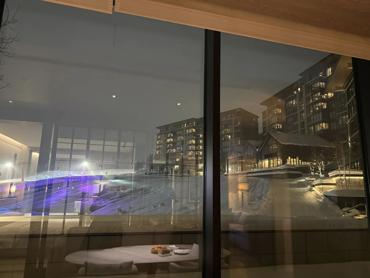 The view from the suite window over snowy grounds to the lit hotel blocks