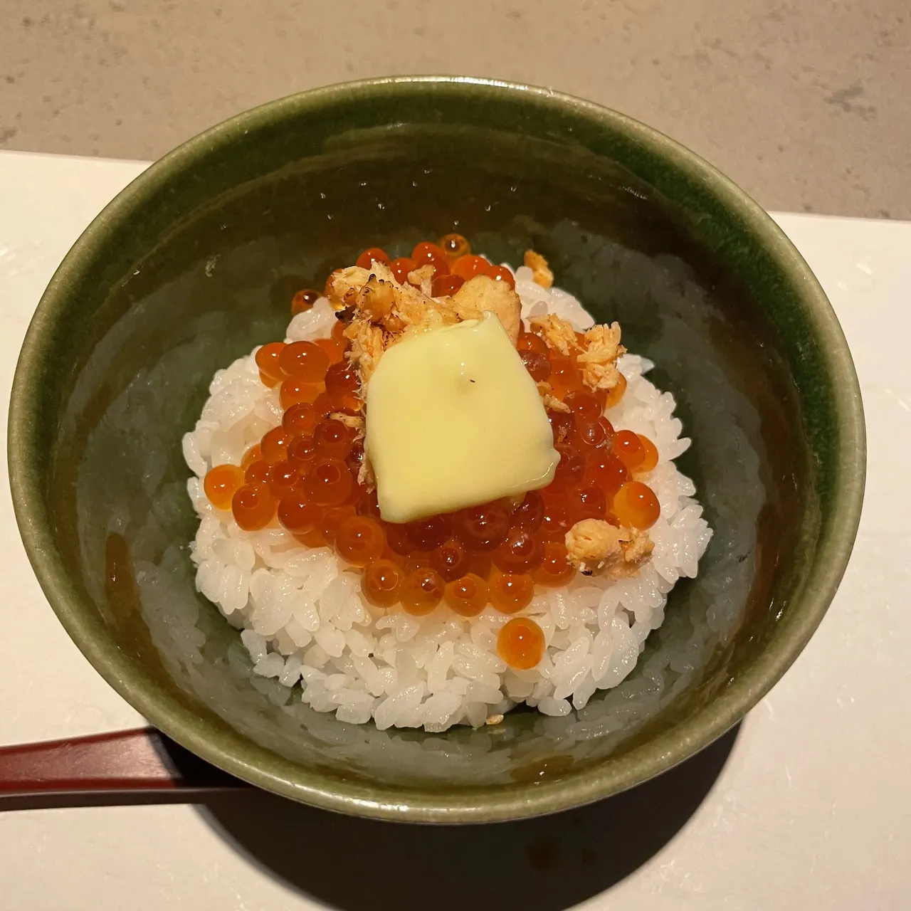 Rice topped with ikura and a pat of butter