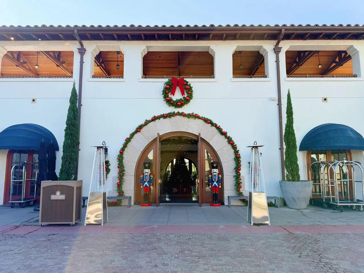 The lobby entrance with a wreath and blue awnings