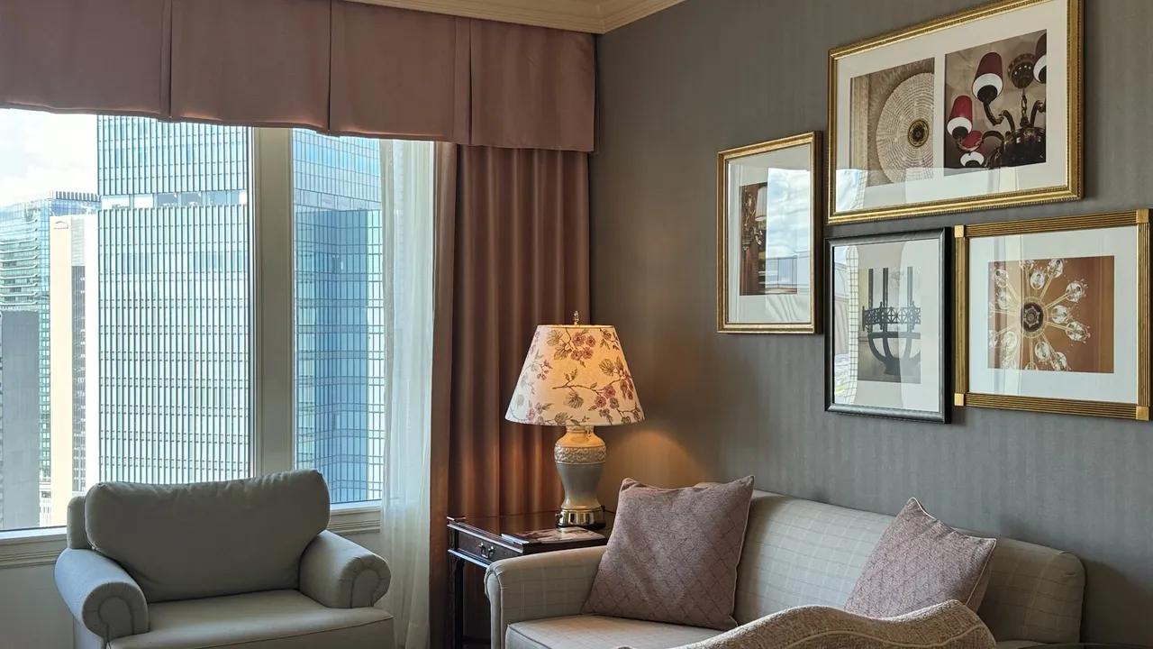 Sofa and framed prints by the corner window