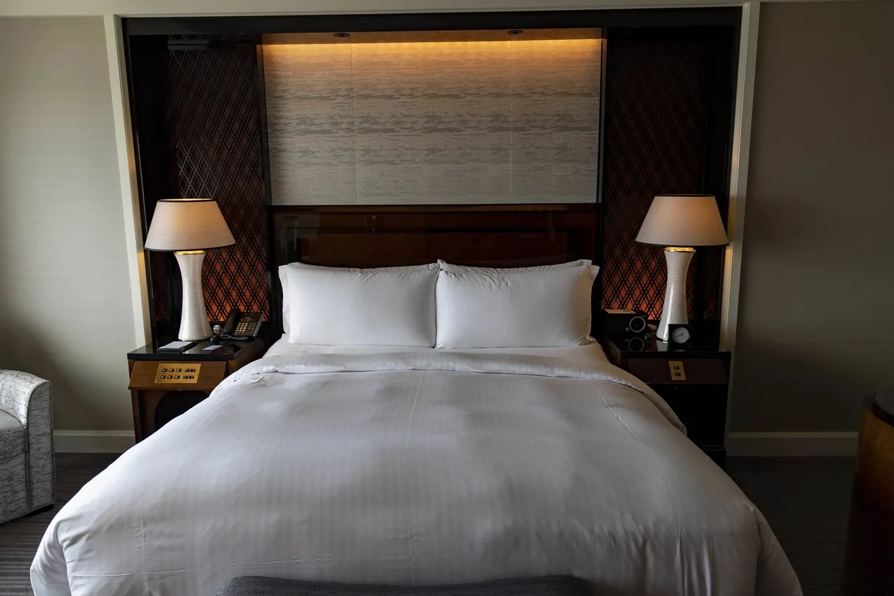 The king bed between two bedside lamps